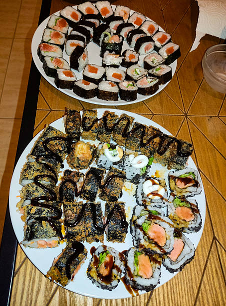 istock Delicious sushi platters, a colorful array of rolls. Represents culinary art, healthy eating,  gourmet dining. Ideal for restaurant ads, food blogs, or lifestyle content. 2209195748