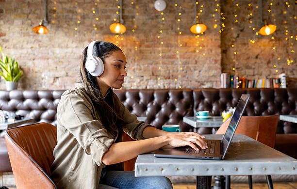 istock Woman working on her laptop at a cafe 2209196478