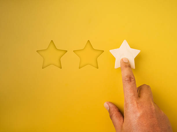 istock 1 star rating reviews button pressed by hand on yellow background. Poor customer satisfaction, low evaluation, negative feedback, specific service or experience survey, business marketing concepts. 2209196590