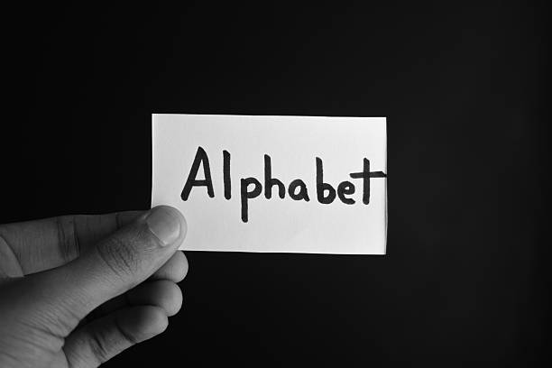 istock Hand holding a paper card with the word ALPHABET 2209196680