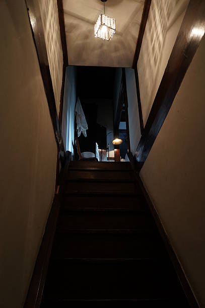 istock Old Wooden Stairs with Warm Light and Shadows 2209197914