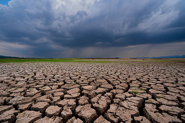 istock The parched ground is cracked and the storm is coming. 2209198594