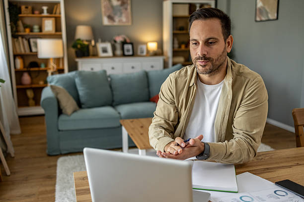 istock Focused businessman working from home having a video call on laptop 2209201056