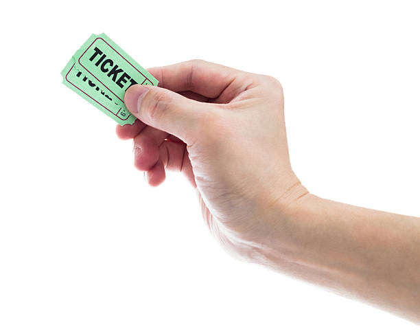 istock Hand holding two green cinema tickets on white background 2209202363