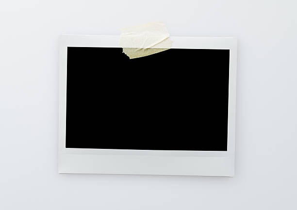 istock Single blank instant picture frame affixed with sticky tape isolated on white background 2209202399