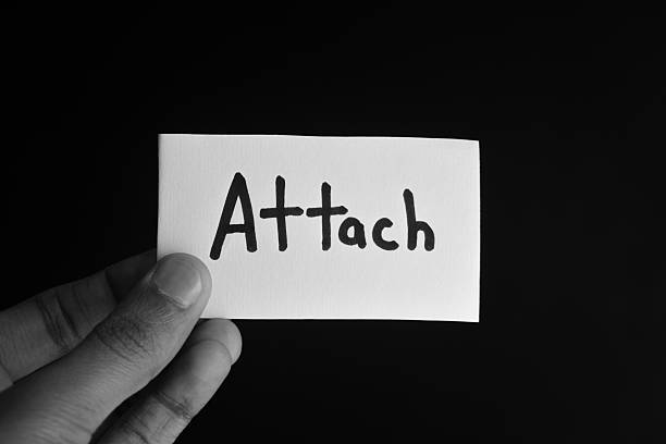 istock Hand holding a paper card with the word ATTACH 2209203316
