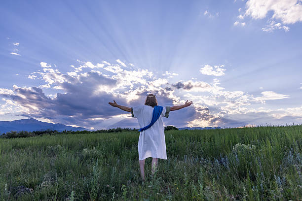 istock Jesus standing in field with dramatic sky 2209204755
