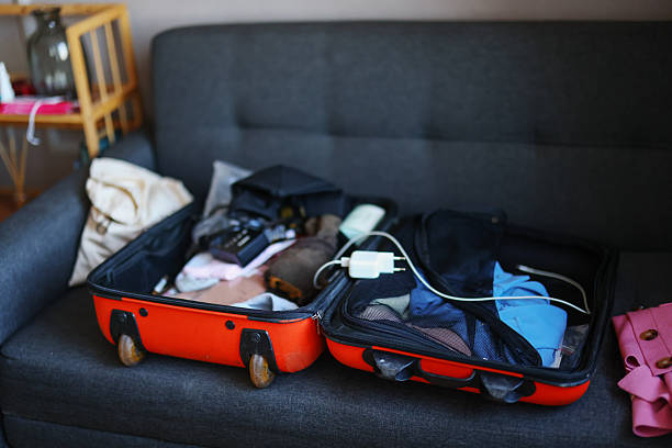 istock Open suitcase with clothes and personal things packed for travelling 2209211622