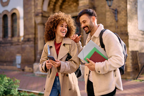 istock Cheerful students laughing and talking together on campus 2209213187