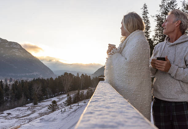 istock Mature couple enjoy sunrise on cabin deck 2209214001