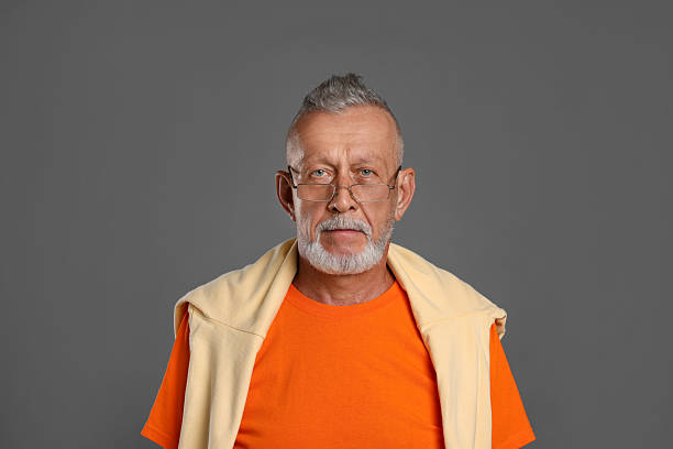 Portrait of a determined man standing outside on a track, expressing confidence and strength.