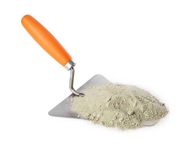 istock Trowel and cement powder isolated on white. Building material 2209220089