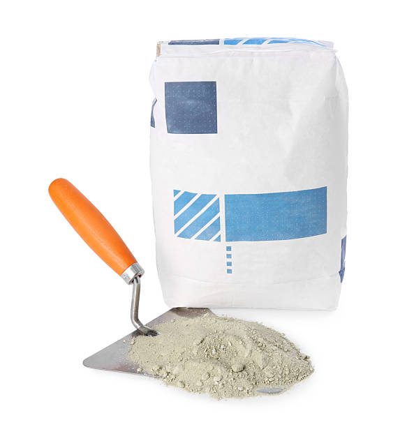 istock Cement powder in bag and trowel isolated on white. Building material 2209220093