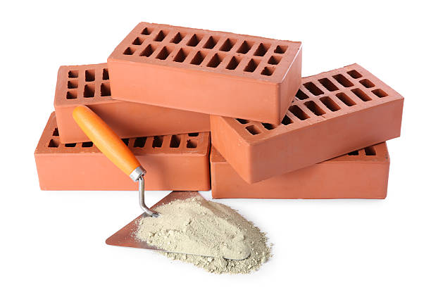 istock Trowel, cement powder and red bricks isolated on white. Building materials 2209220134