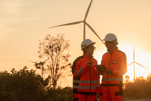 istock Professional Engineer worker service maintenance wind turbine green power clean energy with sunset 2209220622