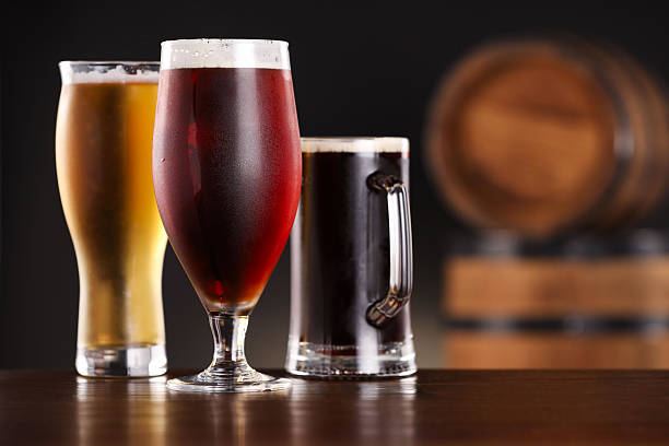 istock Glasses with different types of beer on wooden table in bar. Space for text 2209222219