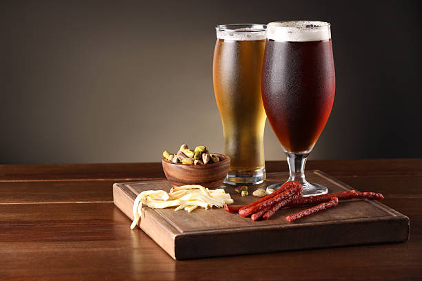 istock Glasses with different types of beer and snacks on wooden table. Space for text 2209222251