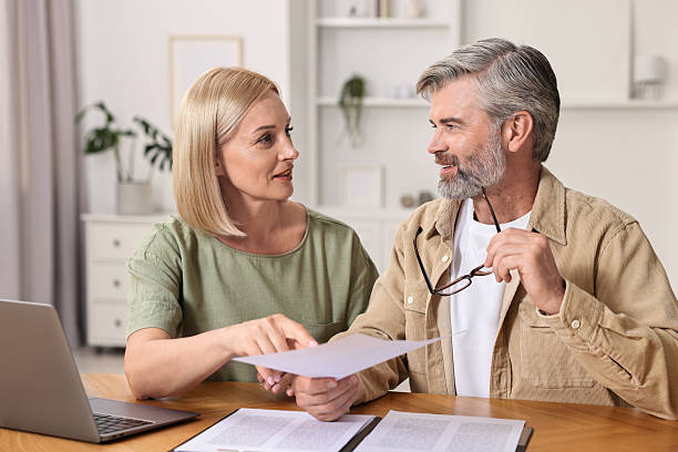 istock Couple planning pension budget at table indoors 2209222630