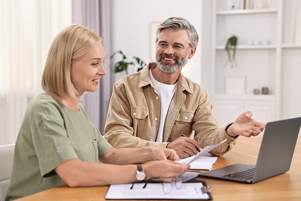 istock Couple planning pension budget at table indoors 2209222730