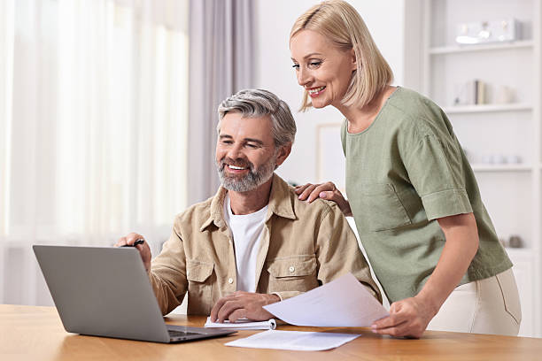 istock Couple planning pension budget at table indoors 2209222761