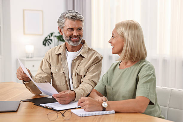istock Couple planning pension budget at table indoors 2209223170