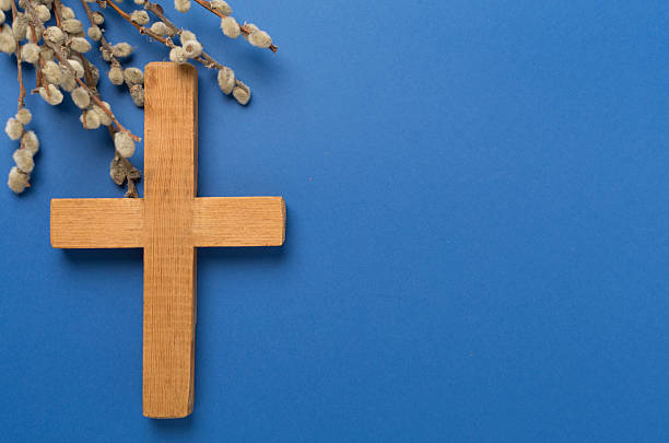 istock Cross with willow branches on wooden background, top, view. Palm Sunday concept 2209223893