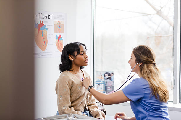 istock Doctor using stethoscope on young woman during medical exam 2209226310