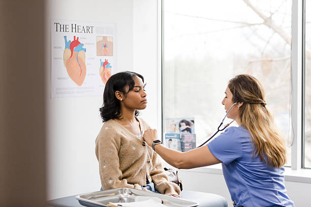 istock Doctor examining young woman's heart during checkup 2209226318