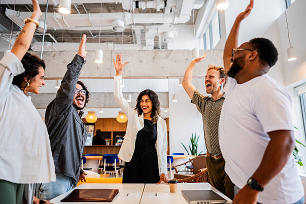 istock Coworkers with hands raised at the office 2209226893