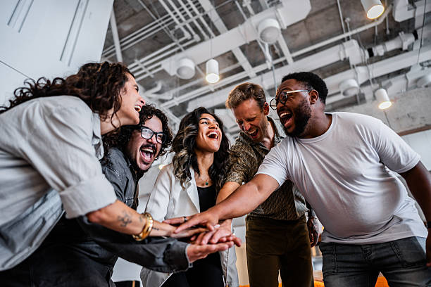 istock Coworkers with hands clasped at the office 2209226898