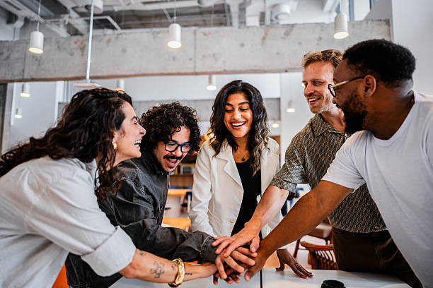 istock Coworkers with hands clasped at the office 2209226899