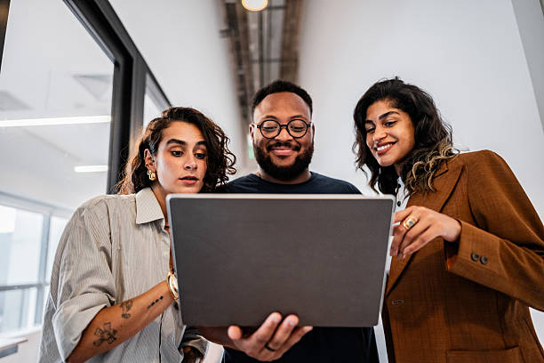 istock Coworkers talking while using the laptop at the office 2209227783