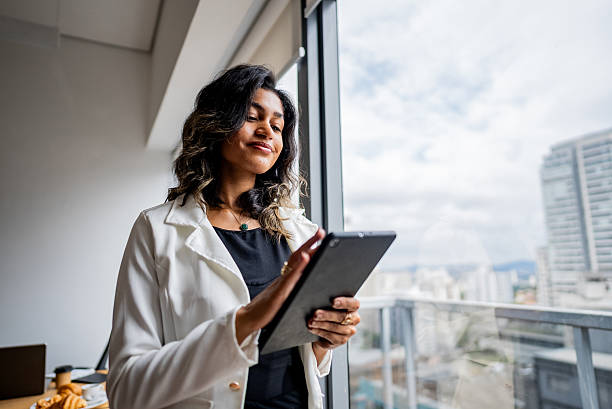 istock Young businesswoman using a digital tablet at the office 2209229010