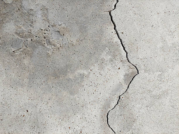 istock An old cracked, concrete wall with crumbling plaster from old age 2209229611