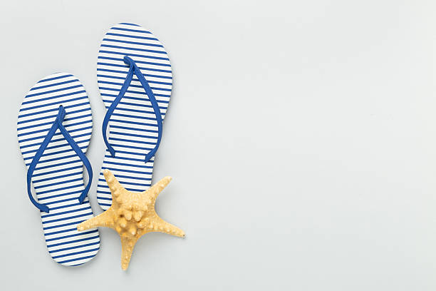 istock Striped blue flip flops on color background, top view 2209233712