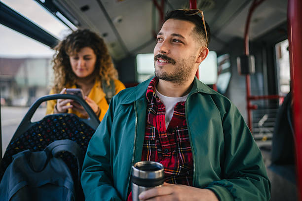istock young man go to work hold thermos while riding a bus in the city 2209234972