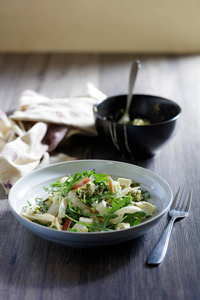 A close view of fresh fennel apple, and rocket leaves salad  with marinated  feta cheese.