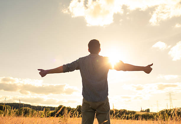 istock Men feeling free and powerful in a beautiful sunset setting. 2209238940