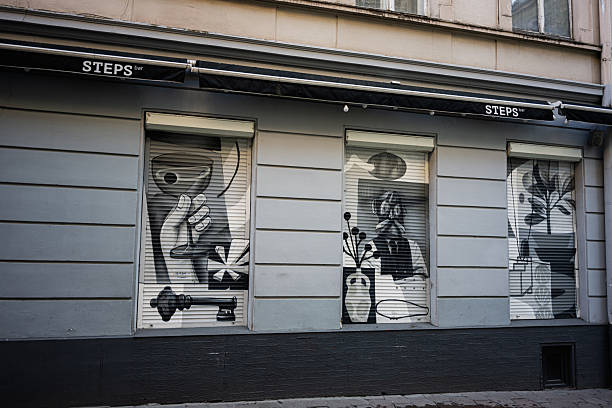 Lviv, Ukraine - April 07, 2025: Bar front in Lviv showcasing artistic monochrome murals on window shades