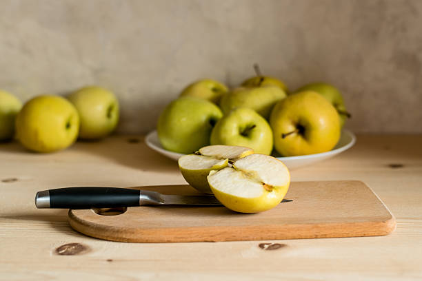 yellow ripe apple with cinnamon on the table, cooking ingredients