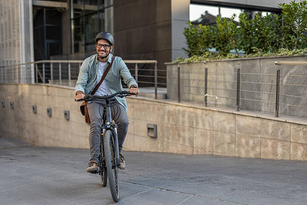 istock Businessman riding electric bicycle in urban setting 2209249189