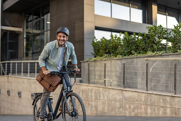 istock Businessman riding bicycle to work in urban setting 2209249770