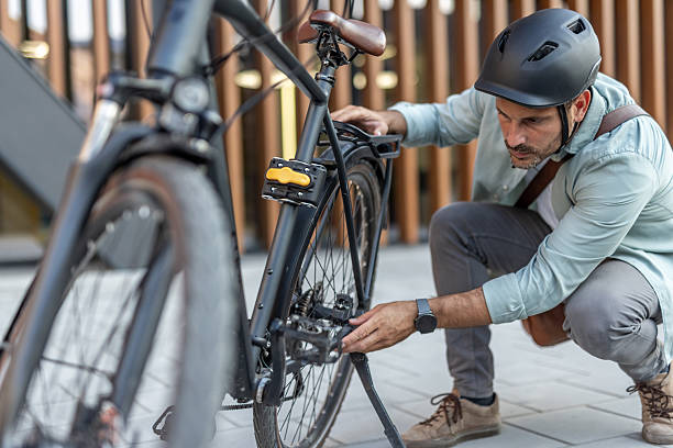 istock Cyclist inspecting his bicycle before riding in the city 2209251662