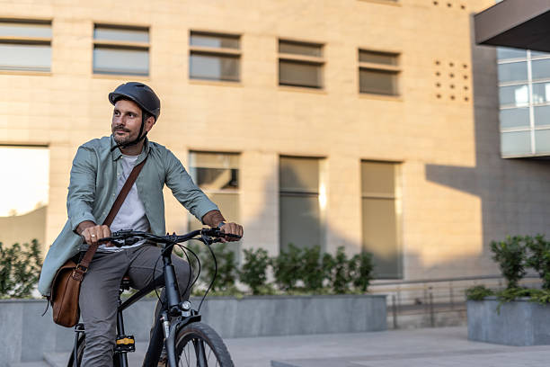 istock Businessman riding bicycle in urban setting 2209251666
