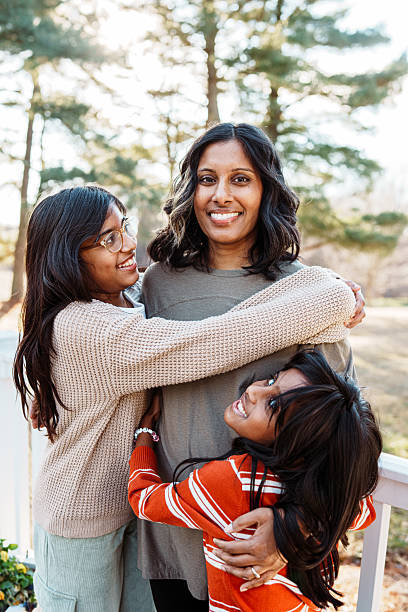 istock Smiling mom with two playful daughters 2209252755