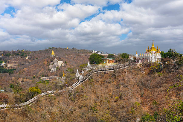Scenic view of sagaing hill dotted with numerous buddhist temples and stupas, showcasing myanmar's rich religious heritage