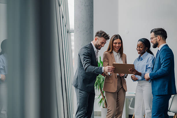 istock Business team smiling while reading a document together in office 2209259891