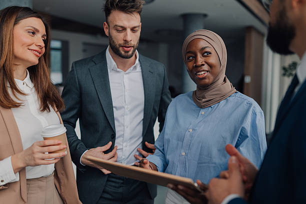 istock Business people discussing work in office lobby 2209259923