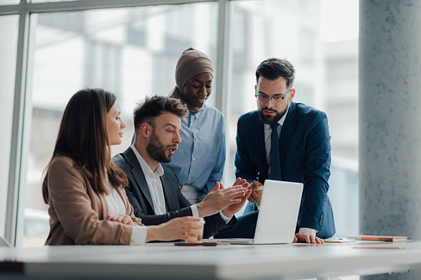 istock Business team discussing work on laptop in modern office 2209259952