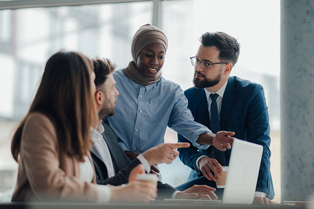 istock Business people collaborating on a project using laptop in office 2209259960